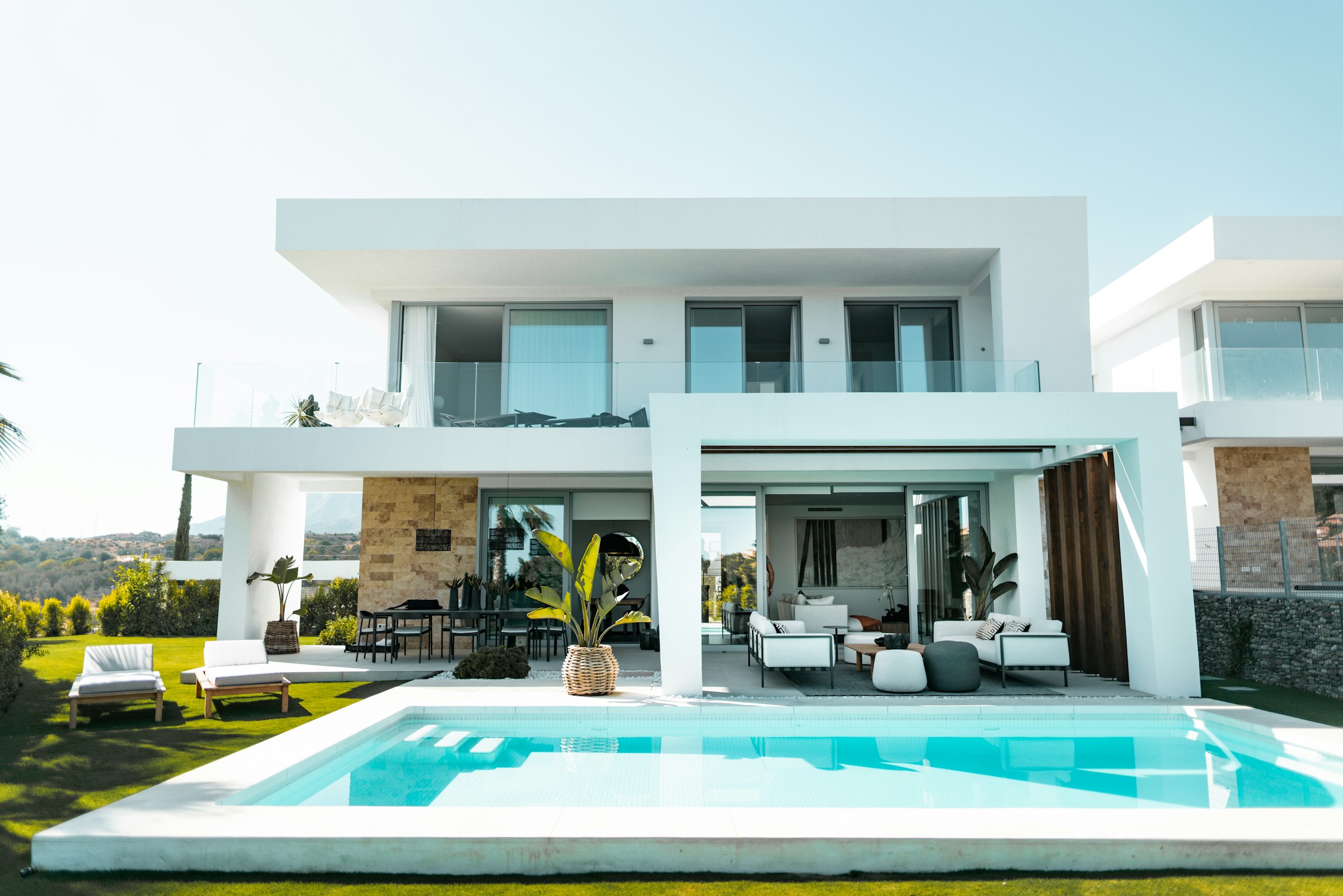 Modern white villa with a swimming pool and landscaped garden